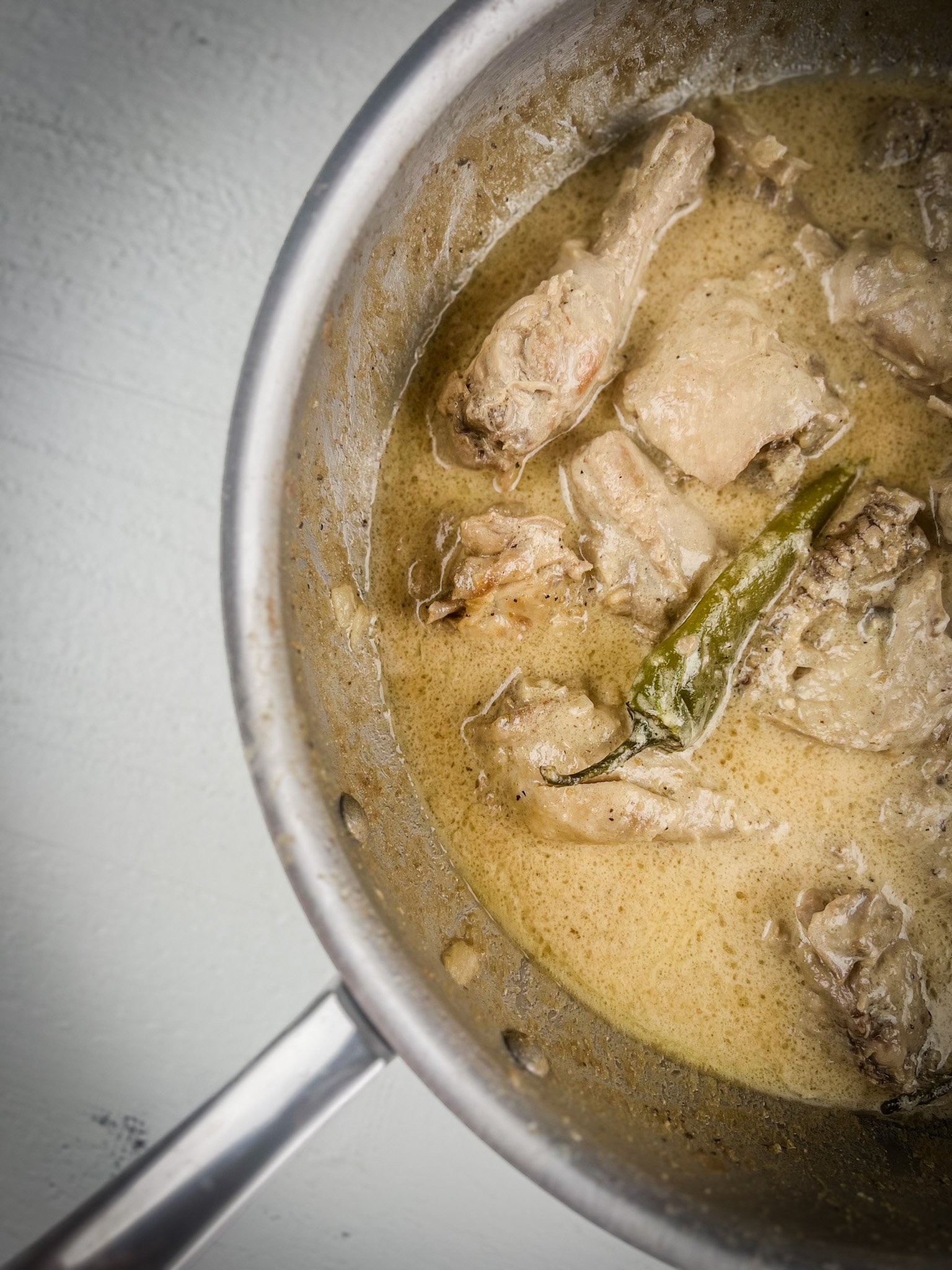 white chicken karahi in a pot half shot.